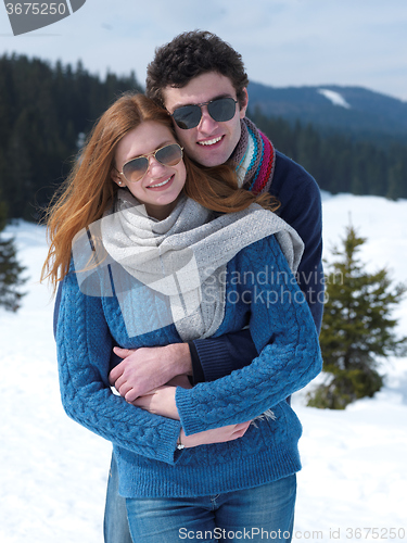 Image of happy young couple having fun on fresh show on winter vacation