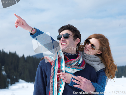 Image of happy young couple having fun on fresh show on winter vacation