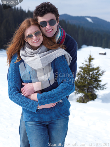 Image of happy young couple having fun on fresh show on winter vacation