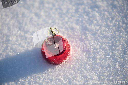 Image of red christmas ball in fresh snow