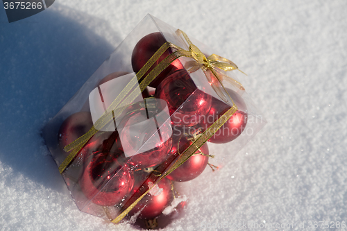 Image of christmas ball in box on fresh  snow