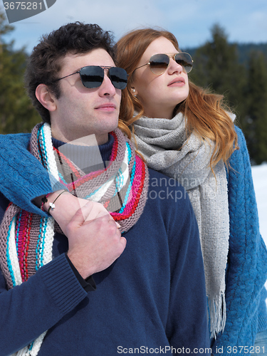 Image of happy young couple having fun on fresh show on winter vacation