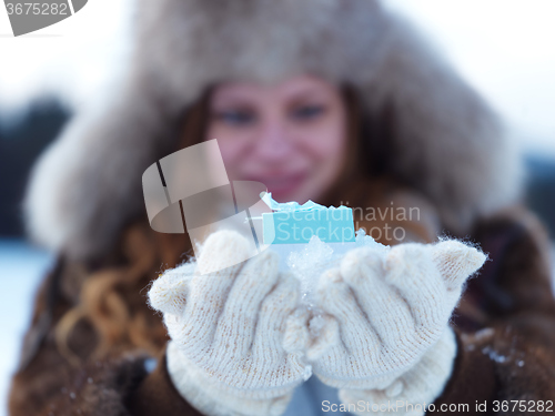 Image of portrait of  girl with gift at winter scene and snow in backgron