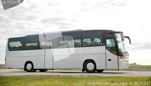 Image of tour bus driving outdoors