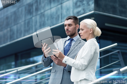 Image of businesspeople with tablet pc outdoors