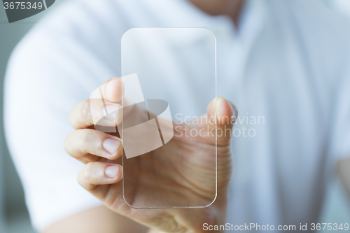 Image of close up of male hand with transparent smartphone