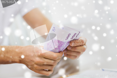 Image of close up of man hands counting money at home