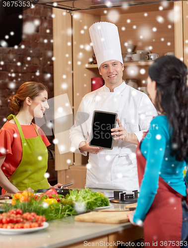 Image of happy women with chef and tablet pc in kitchen