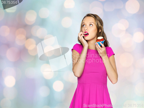 Image of happy woman or teen girl with birthday cupcake