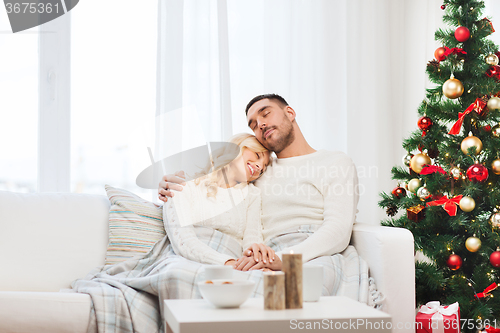 Image of happy couple at home with christmas tree