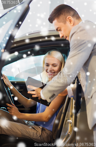 Image of happy woman with car dealer in auto show or salon