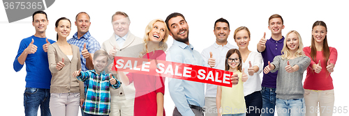 Image of happy people with red sale sign showing thumbs up