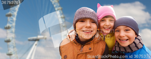 Image of happy little children faces over ferry wheel