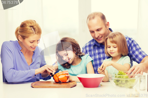 Image of happy family with two kids making dinner at home