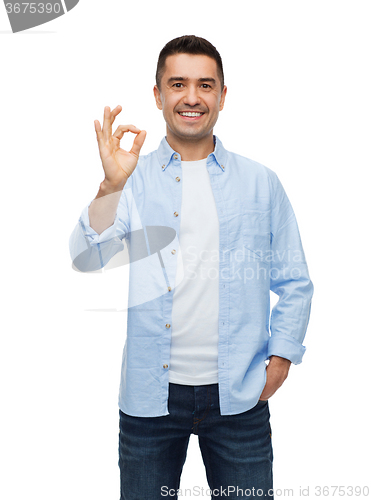 Image of smiling man showing ok hand sign