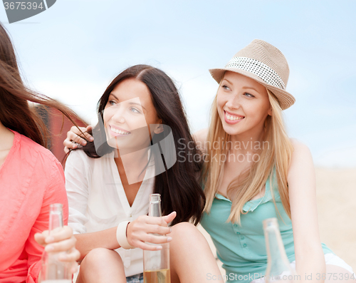 Image of girls with drinks on the beach