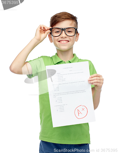 Image of happy boy in eyeglasses holding school test result