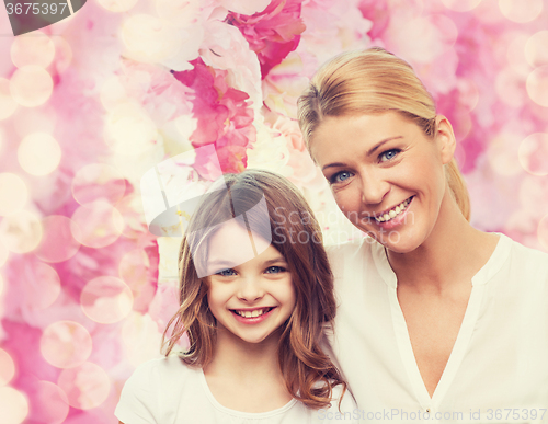 Image of smiling mother and little girl