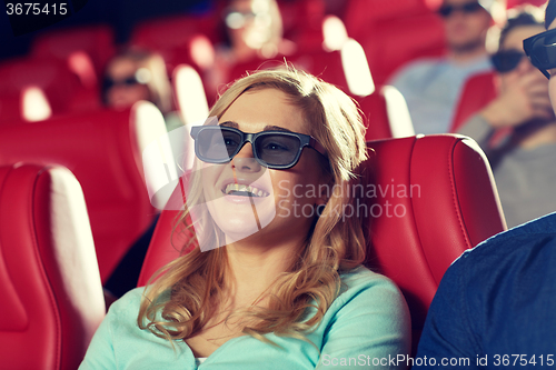 Image of happy young woman watching movie in theater