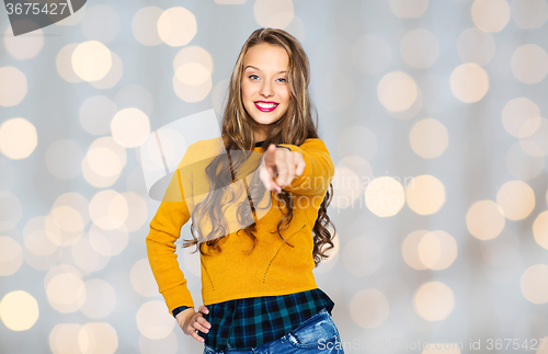 Image of happy young woman or teen pointing finger on you