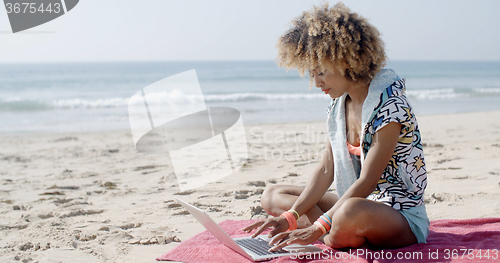 Image of Girl Working With Laptop On The Sand Beach