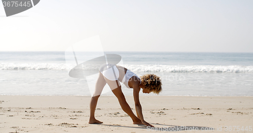 Image of Woman Practicing Yoga At Seashore