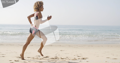 Image of Woman Running On The Beach