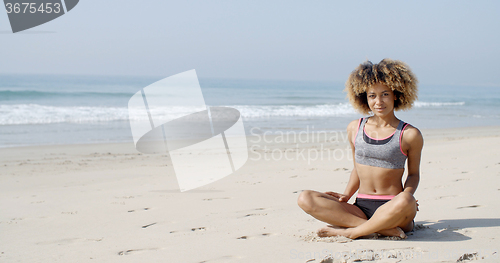 Image of Woman Sitting On The Beach In Lotus Pose