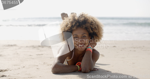 Image of Woman In A Swimsuit Relaxing On The Sand