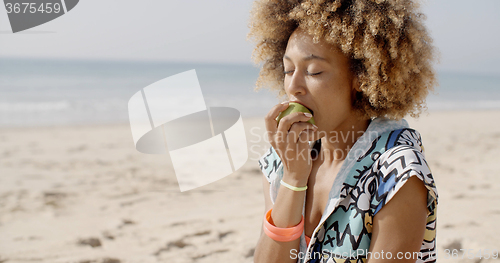 Image of Woman Eating A Green Apple 