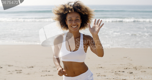 Image of Woman Running On The Beach And Waving