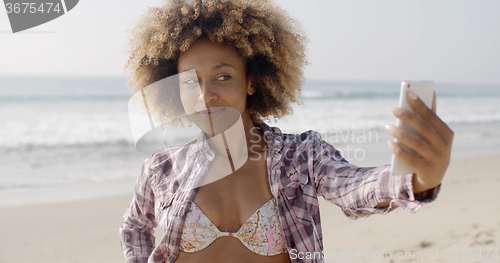 Image of Woman Posing To Take A Selfie On The Beach