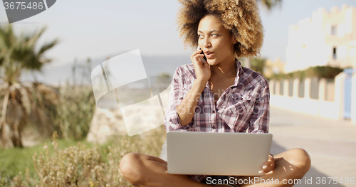 Image of Young African Woman Working On Laptop In Nature.