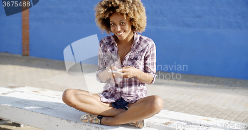Image of Female Using Mobile Phone On A Road