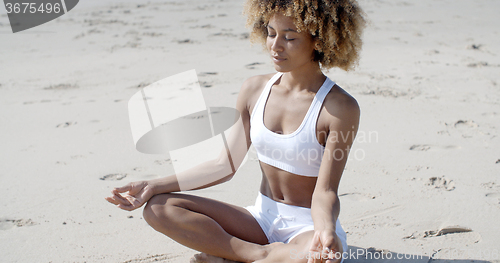 Image of Woman Meditating On Beach In Lotus Position