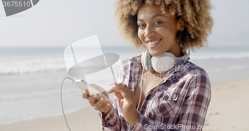 Image of Girl On Beach Listening To Music