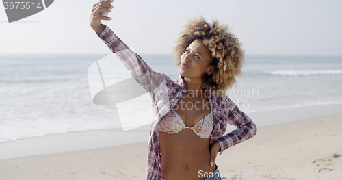 Image of Woman Posing To Take A Selfie On The Beach