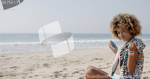 Image of Young Woman With Earphones On The Sea Coast
