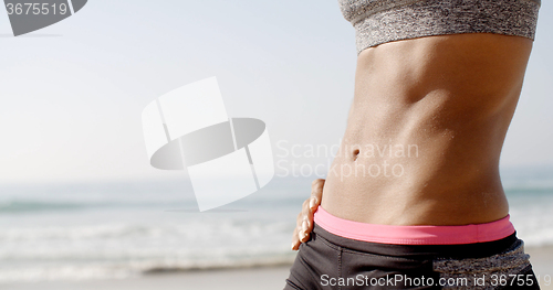 Image of Young Fit Woman\'s Belly Outdoors In Summer