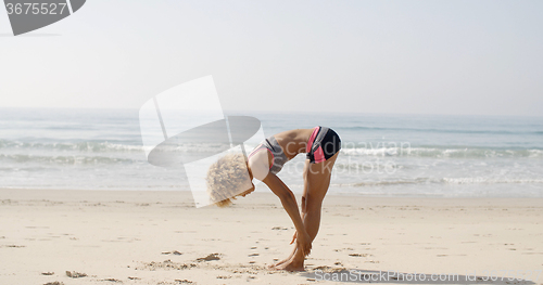 Image of Female Athlete Doing Exercise On Beach