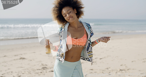 Image of Happy Woman Dancing On A Beach