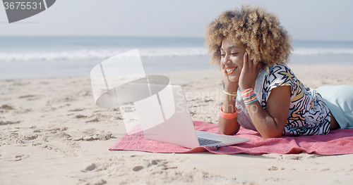 Image of Woman On The Beach Using A Computer