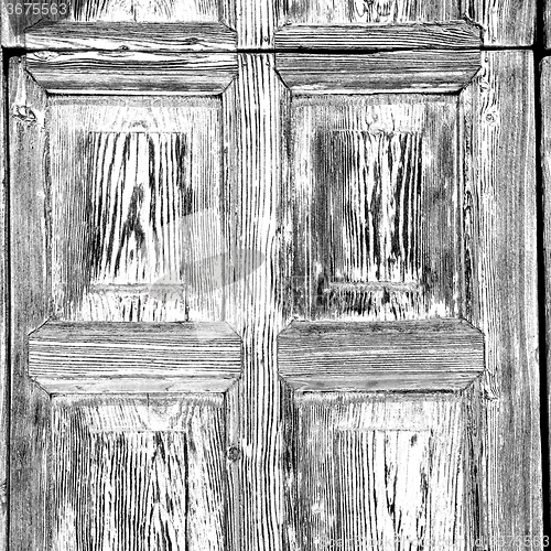 Image of grain texture of a brown antique wooden old door in italy   euro
