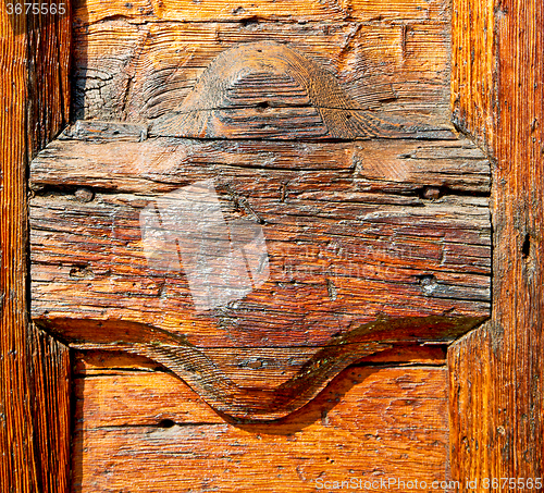 Image of grain texture of a brown antique wooden old door in italy   euro