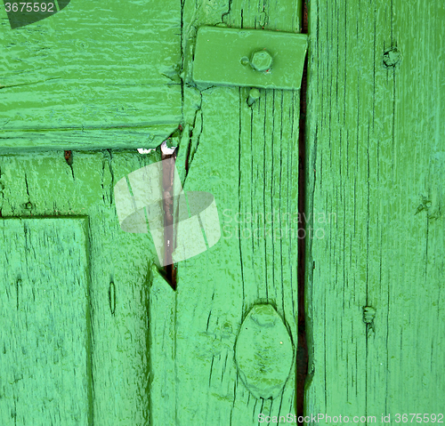 Image of  piece of colorated green wood as a window