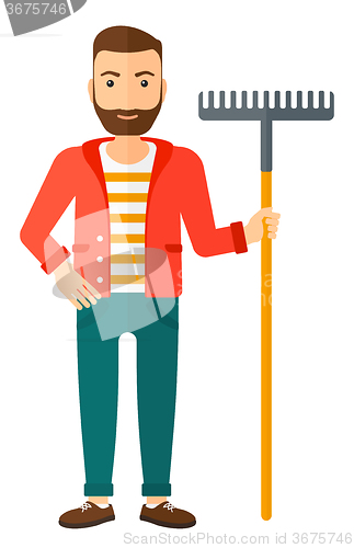 Image of Man standing with rake.