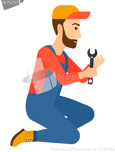 Image of Repairman holding spanner.