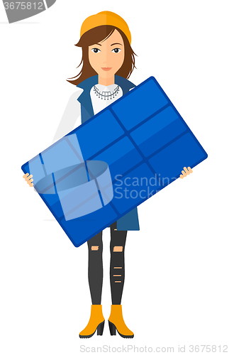 Image of Woman holding solar panel.