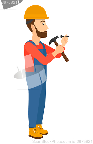 Image of Man hammering nail.