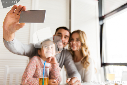 Image of close up of family taking selfie at restaurant